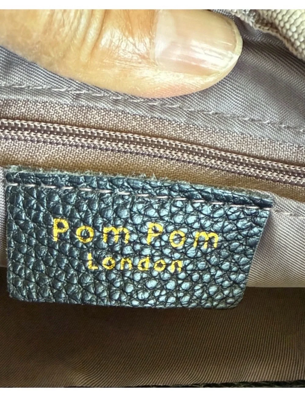 Compact Black Pebble Crossbody with Patterned Strap